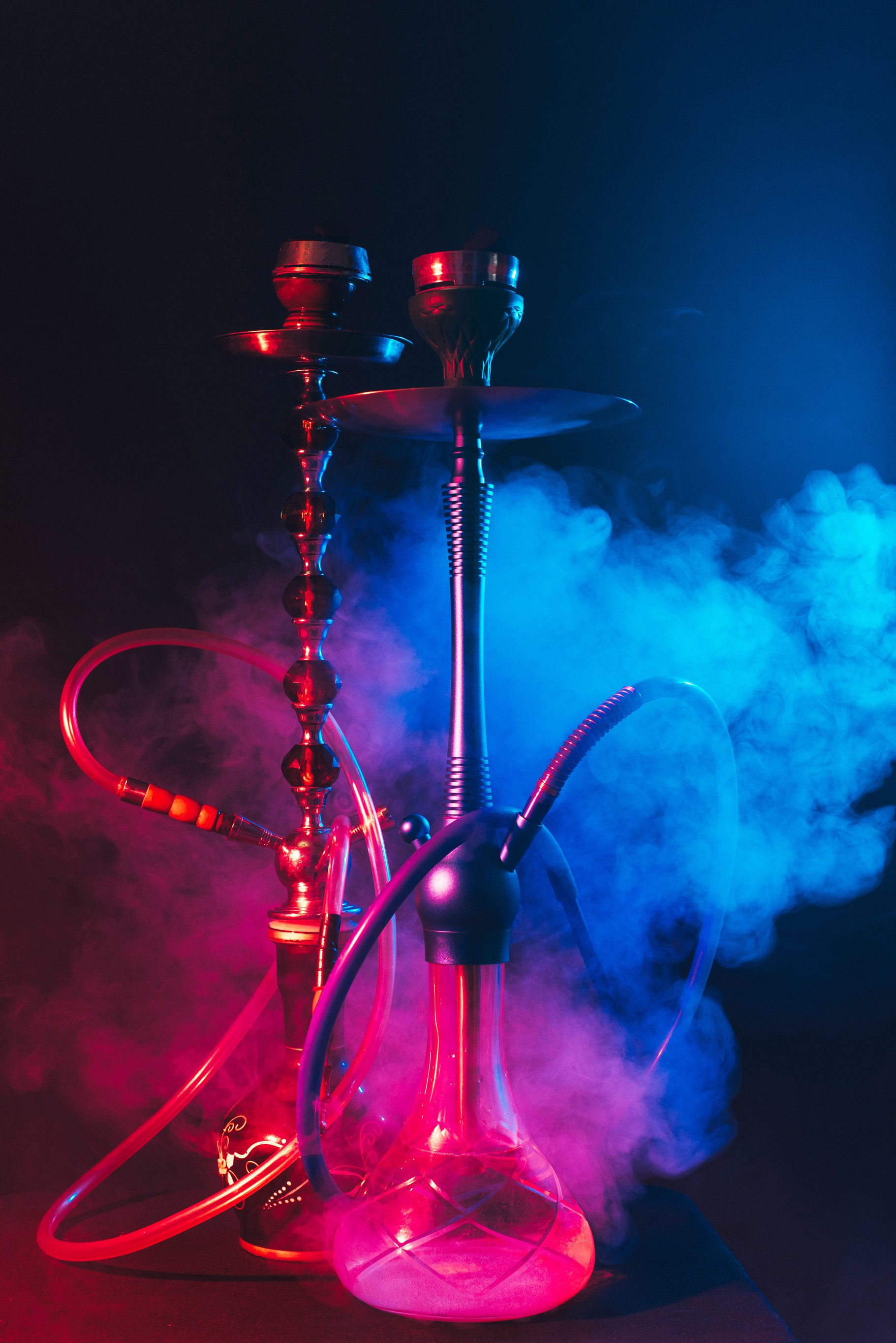 Modern Hookah, Shisha on a Smoky Black Background with Neon Ligh